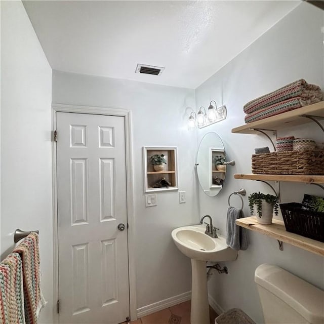 bathroom featuring tile patterned floors and toilet