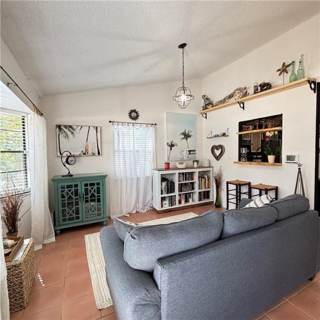 living room with lofted ceiling, tile patterned flooring, and plenty of natural light