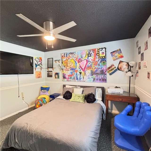 bedroom with ceiling fan and a textured ceiling