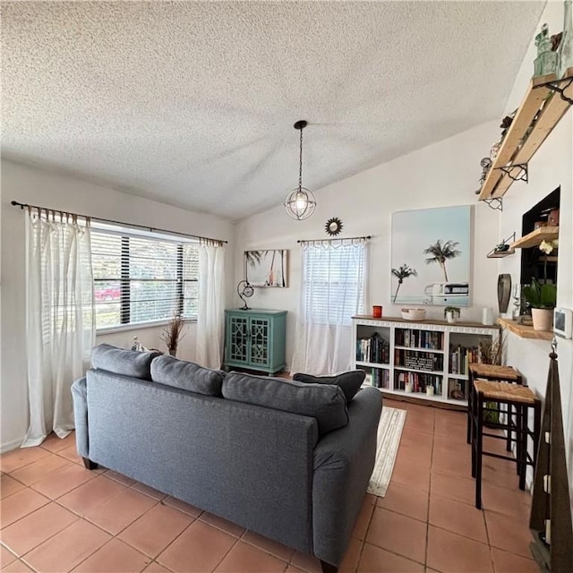 living room with lofted ceiling, a textured ceiling, tile patterned floors, and a healthy amount of sunlight