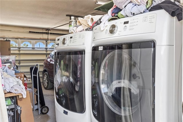 laundry room with a garage, laundry area, and independent washer and dryer