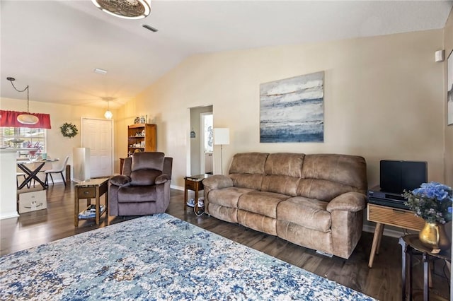 living room with lofted ceiling, wood finished floors, visible vents, and baseboards