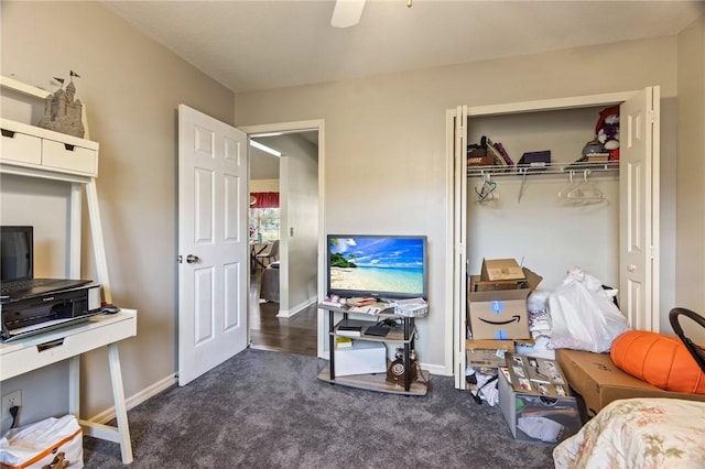 bedroom featuring dark colored carpet, a closet, a ceiling fan, and baseboards