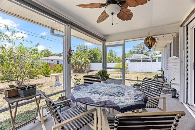 sunroom / solarium with a ceiling fan