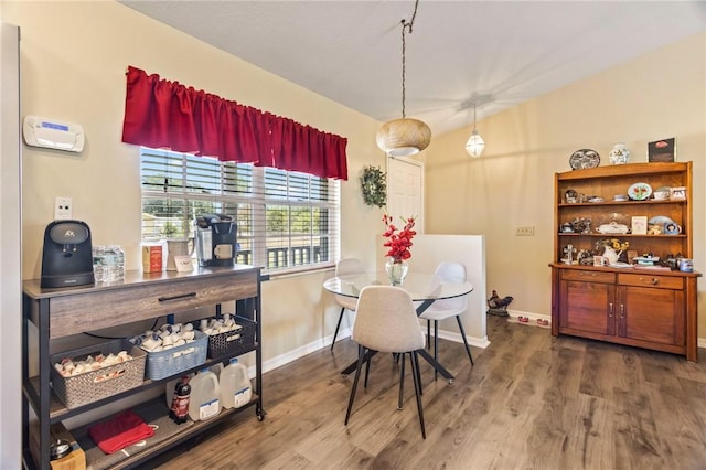 dining area featuring baseboards and wood finished floors