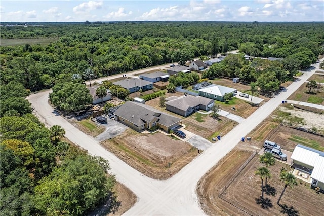 bird's eye view with a wooded view