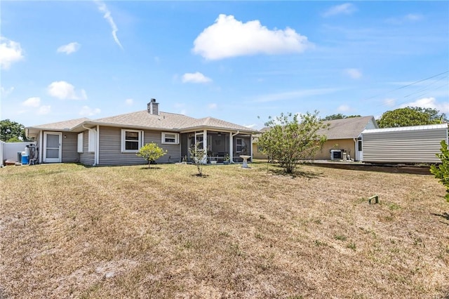 back of house featuring a yard, central AC, and a sunroom