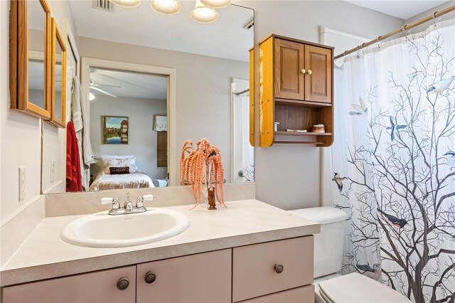 ensuite bathroom with toilet, visible vents, ensuite bath, and vanity