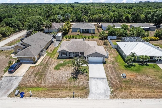 drone / aerial view with a residential view and a view of trees