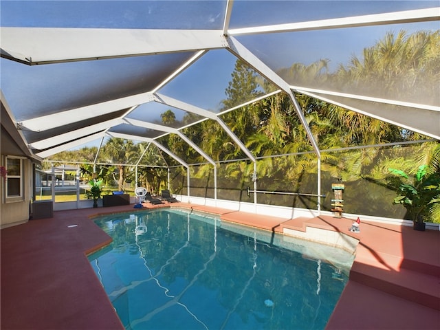 view of pool featuring a patio and glass enclosure