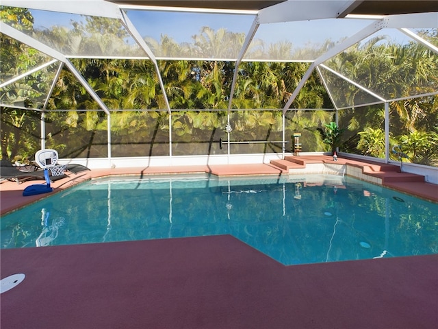 view of swimming pool with a lanai