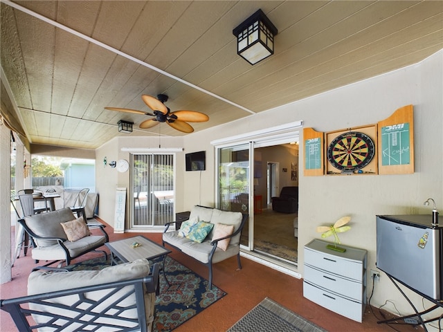 sunroom with wooden ceiling and ceiling fan