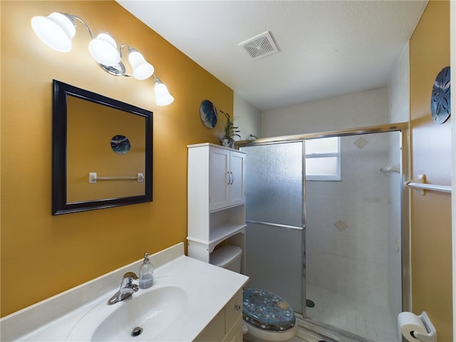 bathroom with walk in shower, vanity, and toilet