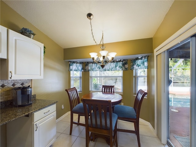 dining space with light tile patterned flooring, a chandelier, and a wealth of natural light