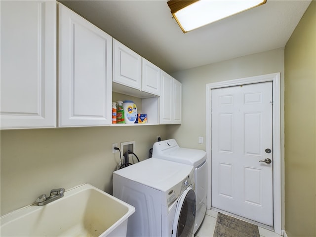 washroom with washer and dryer, sink, light tile patterned floors, and cabinets