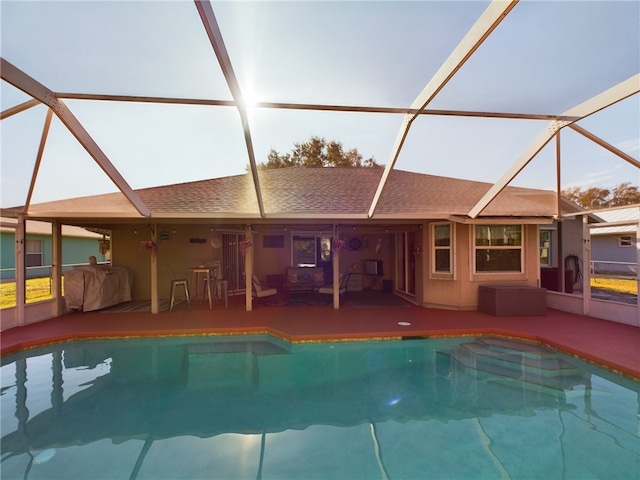 view of swimming pool with a lanai and a patio