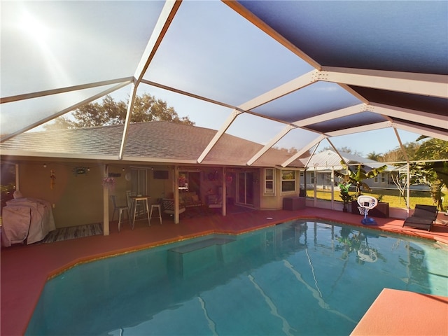 view of swimming pool with a lanai and a patio area