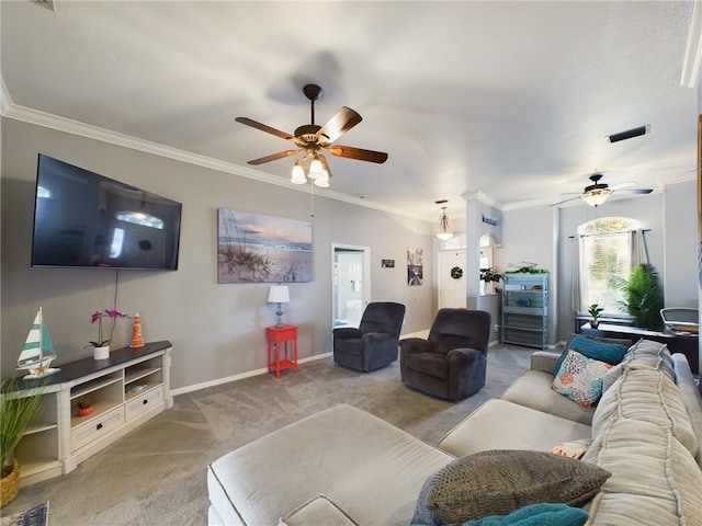 carpeted living room with ornamental molding and ceiling fan