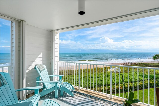 balcony with a view of the beach and a water view