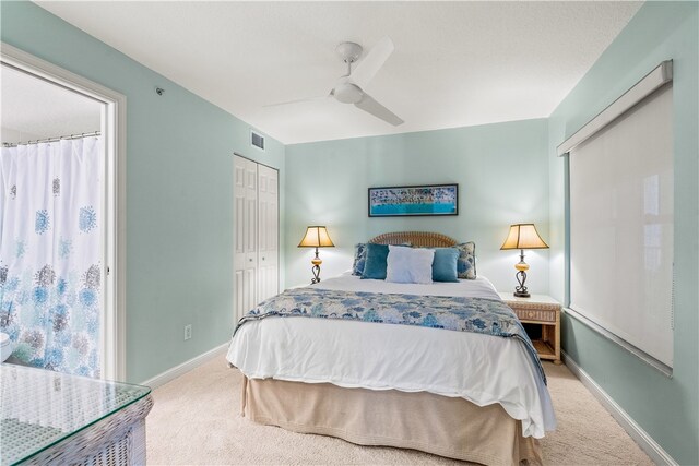 carpeted bedroom featuring ceiling fan and a closet