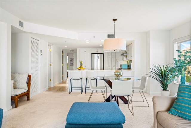 carpeted dining room with sink