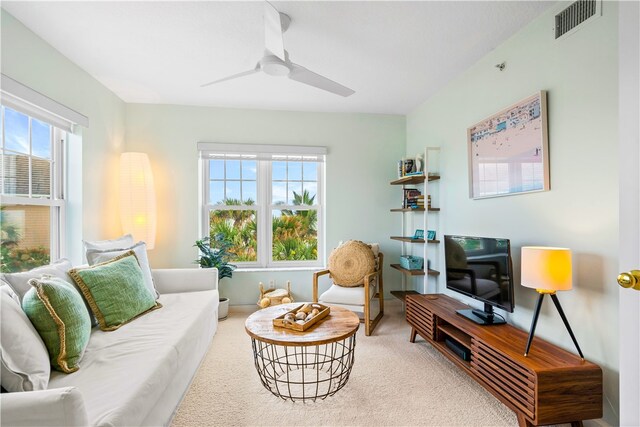 carpeted living room featuring ceiling fan