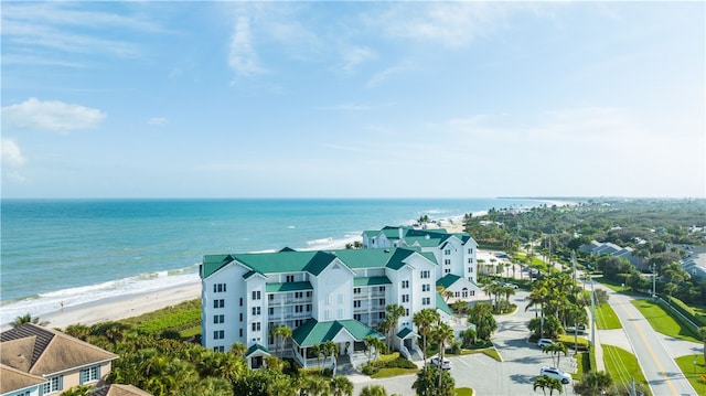 bird's eye view featuring a water view and a beach view