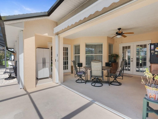 view of patio with ceiling fan, outdoor dining area, and french doors