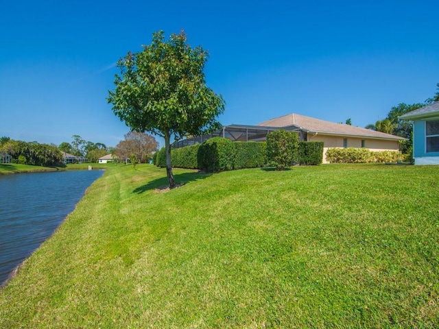 view of yard featuring a water view and a lanai