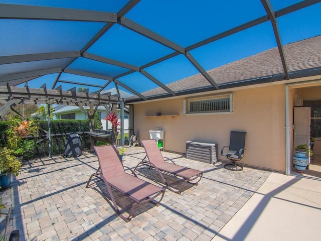 view of patio featuring a lanai