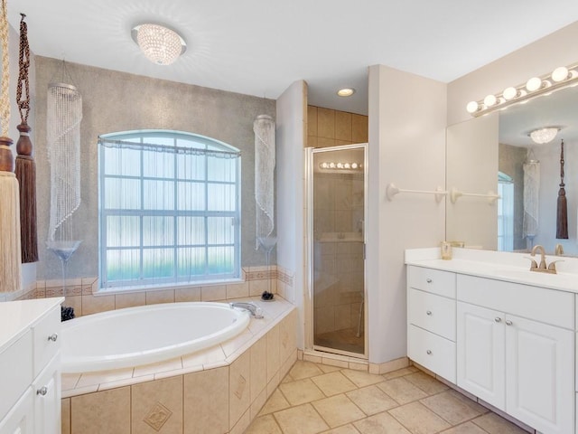 bathroom featuring a garden tub, a shower stall, vanity, and tile patterned floors