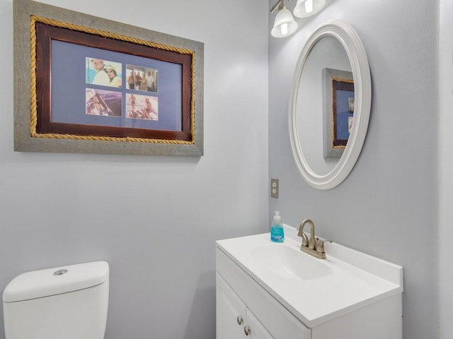 bathroom featuring toilet and vanity