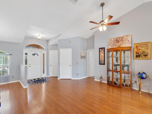 entrance foyer featuring high vaulted ceiling, wood finished floors, visible vents, a ceiling fan, and baseboards