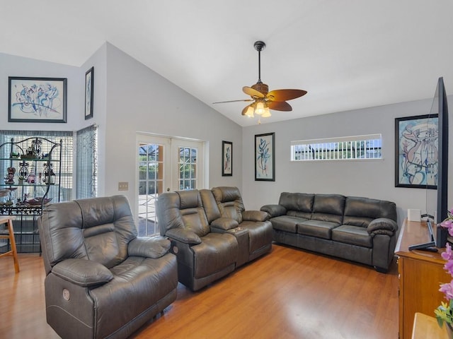 living room featuring ceiling fan, light wood-style flooring, vaulted ceiling, and french doors