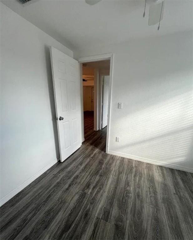 unfurnished room featuring dark wood-type flooring