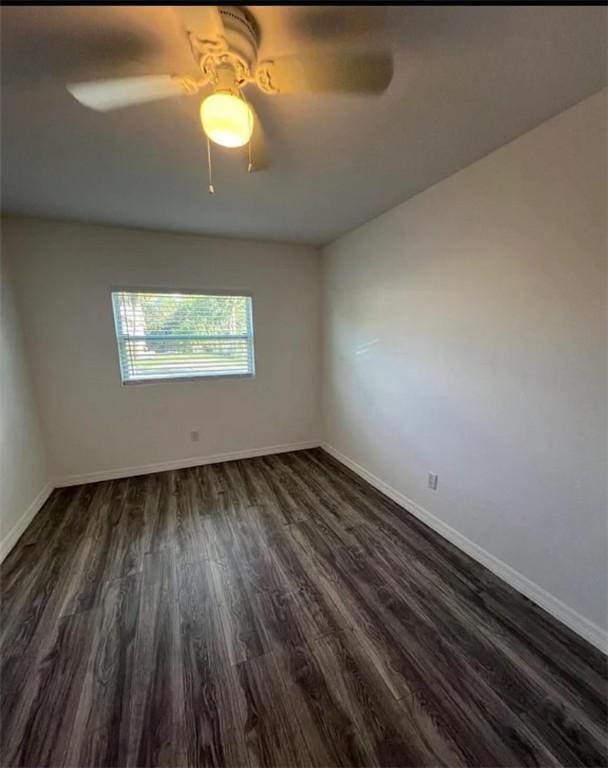 unfurnished room with dark hardwood / wood-style flooring