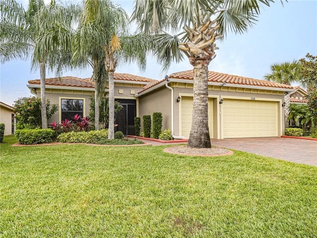 mediterranean / spanish-style home with a front lawn and a garage