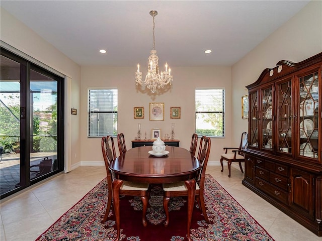 dining room featuring light tile patterned floors and a notable chandelier