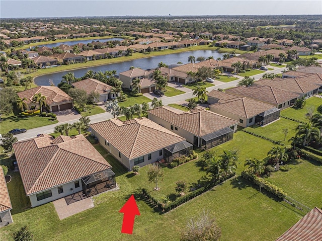 birds eye view of property with a water view