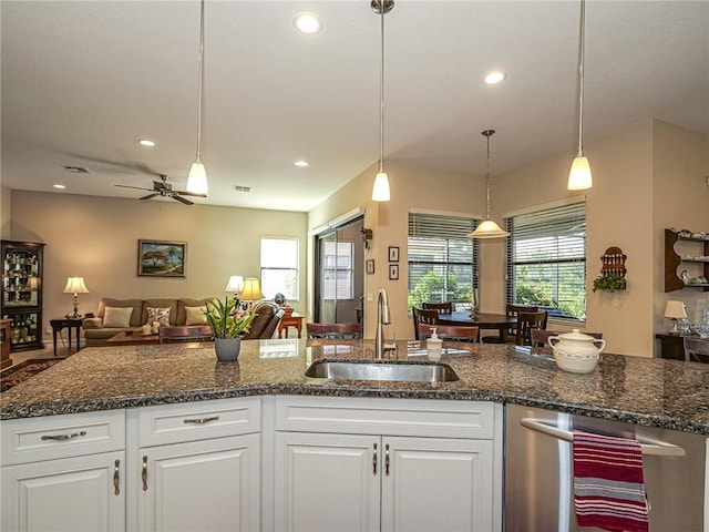 kitchen with white cabinets, ceiling fan, sink, and hanging light fixtures