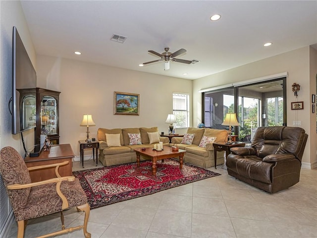 living room with ceiling fan and light tile patterned flooring