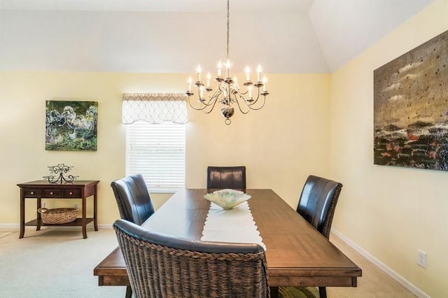 carpeted dining space with vaulted ceiling, an inviting chandelier, and baseboards