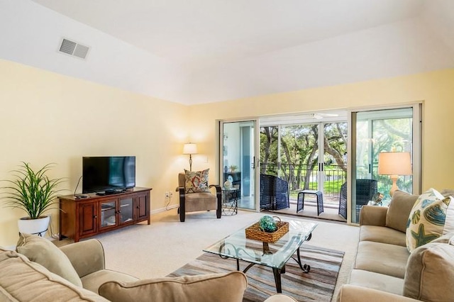 carpeted living area with baseboards and visible vents