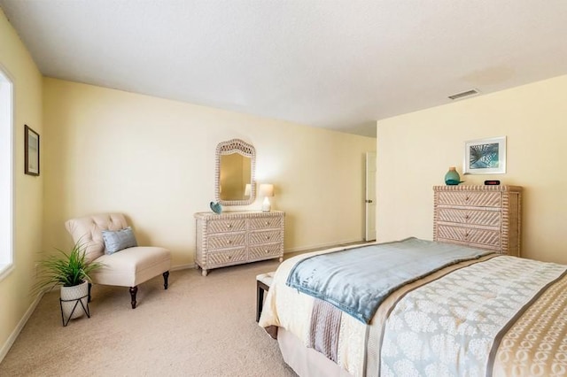 bedroom with carpet floors, visible vents, and baseboards