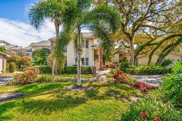 view of front of house with a front lawn and stucco siding