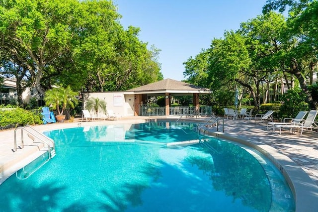 pool featuring a patio and fence