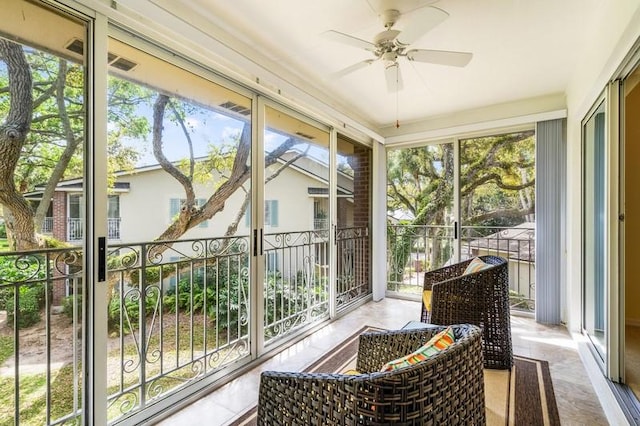 sunroom featuring a healthy amount of sunlight and ceiling fan