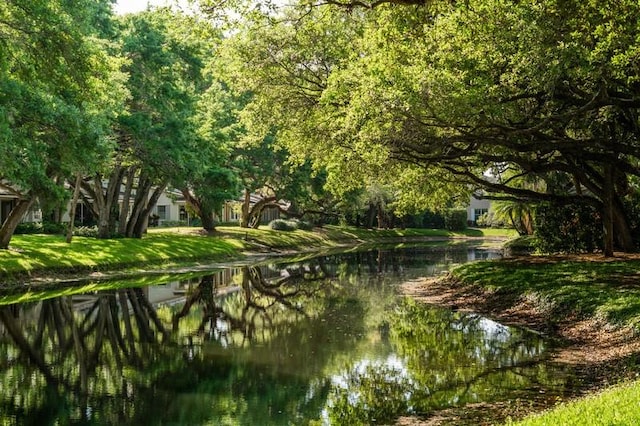 surrounding community featuring a water view and a yard