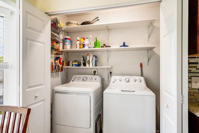 clothes washing area featuring washing machine and dryer and laundry area