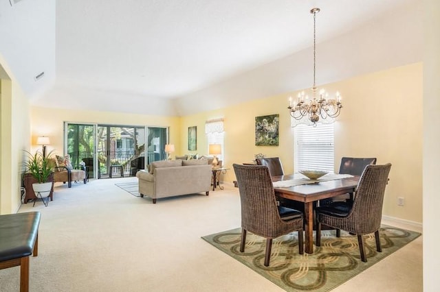 carpeted dining area featuring baseboards and an inviting chandelier